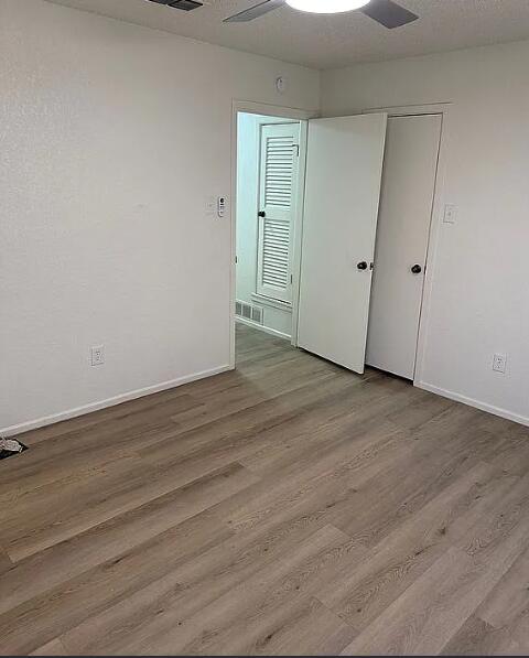 5232 95th Street Lubbock, TX 79424 - Photo 22 of 35 a view of an empty room with wooden floor