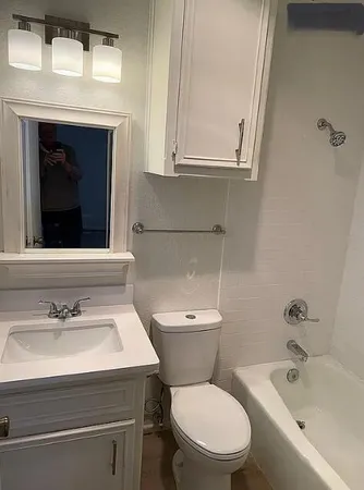 a bathroom with a sink toilet and tub