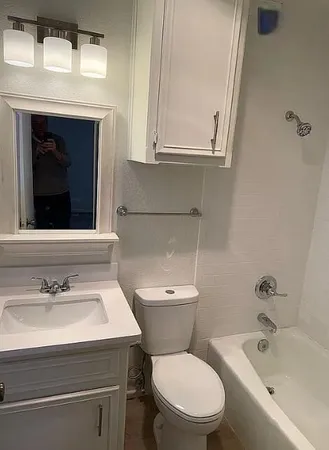 a bathroom with a sink toilet and tub