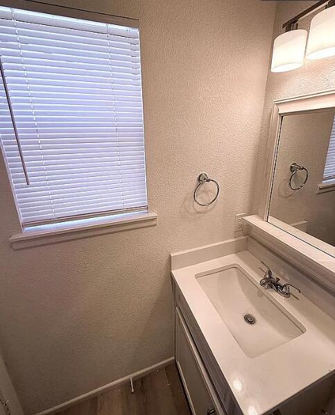 5232 95th Street Lubbock, TX 79424 - Photo 29 of 35 a bathroom with a sink and a mirror