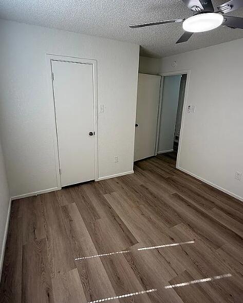 5232 95th Street Lubbock, TX 79424 - Photo 33 of 35 a view of an empty room with wooden floor