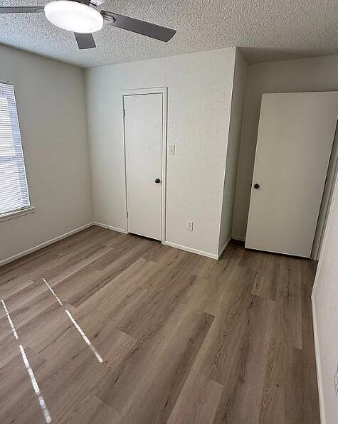 5232 95th Street Lubbock, TX 79424 - Photo 34 of 35 an empty room with wooden floor and windows