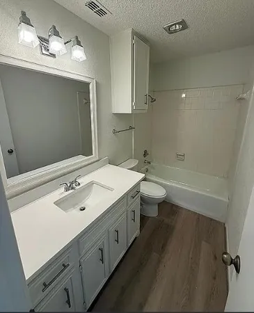 a bathroom with a double vanity sink mirror and toilet