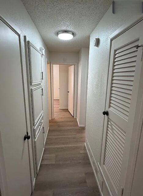 5232 95th Street Lubbock, TX 79424 - Photo 9 of 35 a view of a hallway with wooden floor and staircase