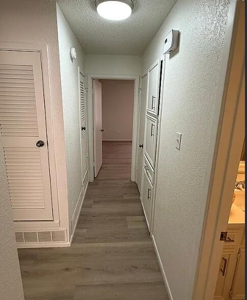 5232 95th Street Lubbock, TX 79424 - Photo 10 of 35 a view of a hallway with wooden floor and staircase