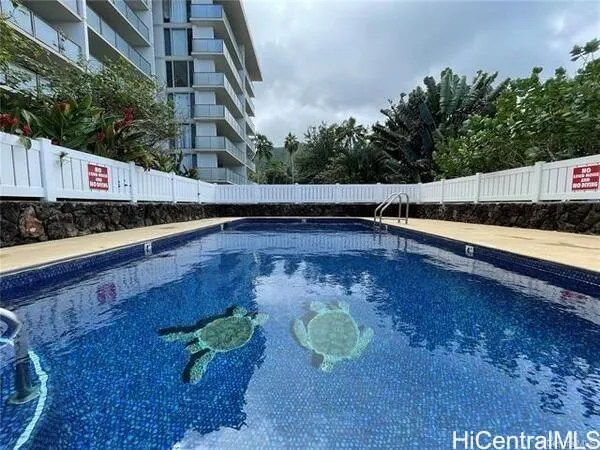 a view of a swimming pool with an outdoor seating