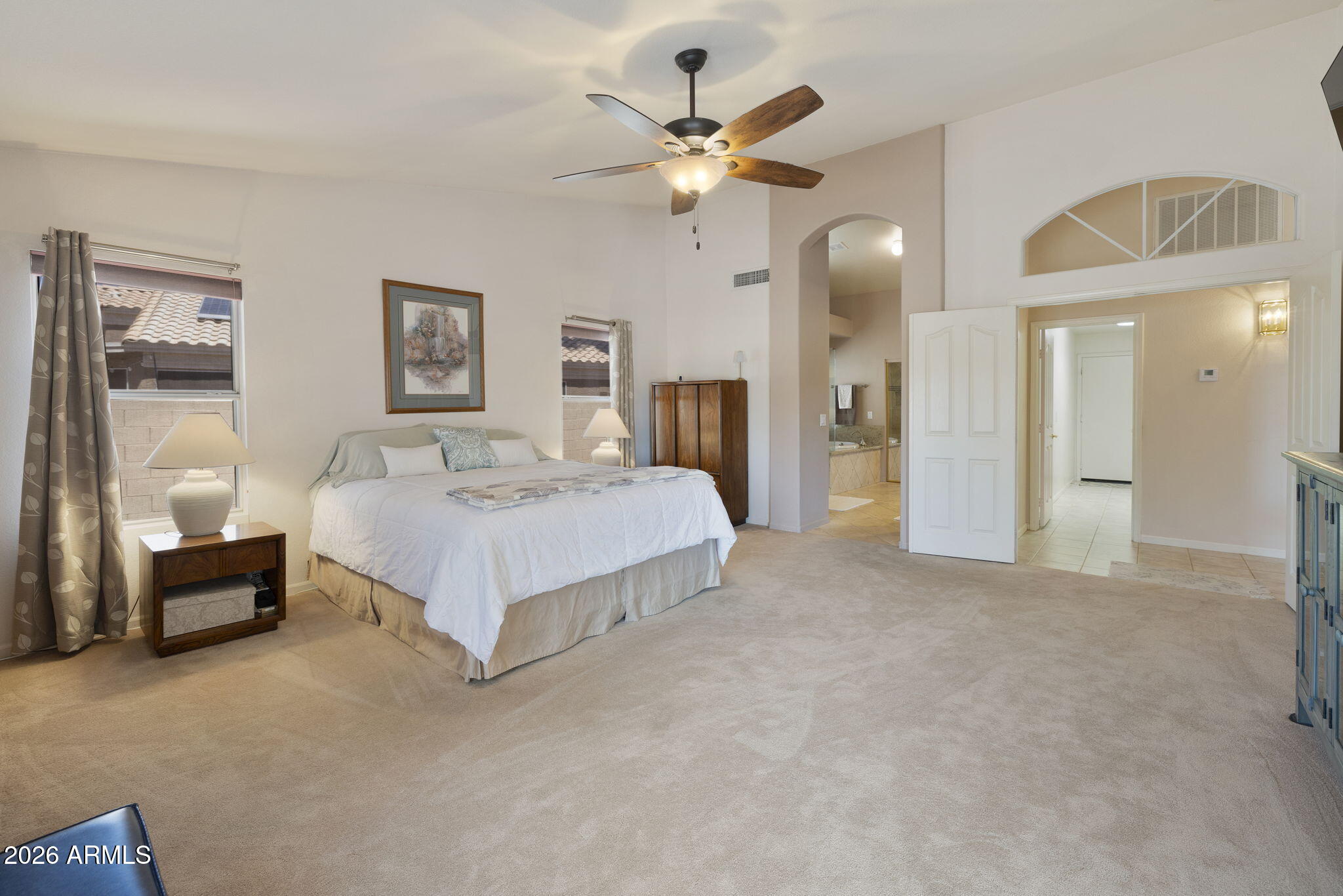 12435 West Monte Vista Road Avondale, AZ 85392 - Photo 36 of 69 a spacious bedroom with a bed and a chandelier