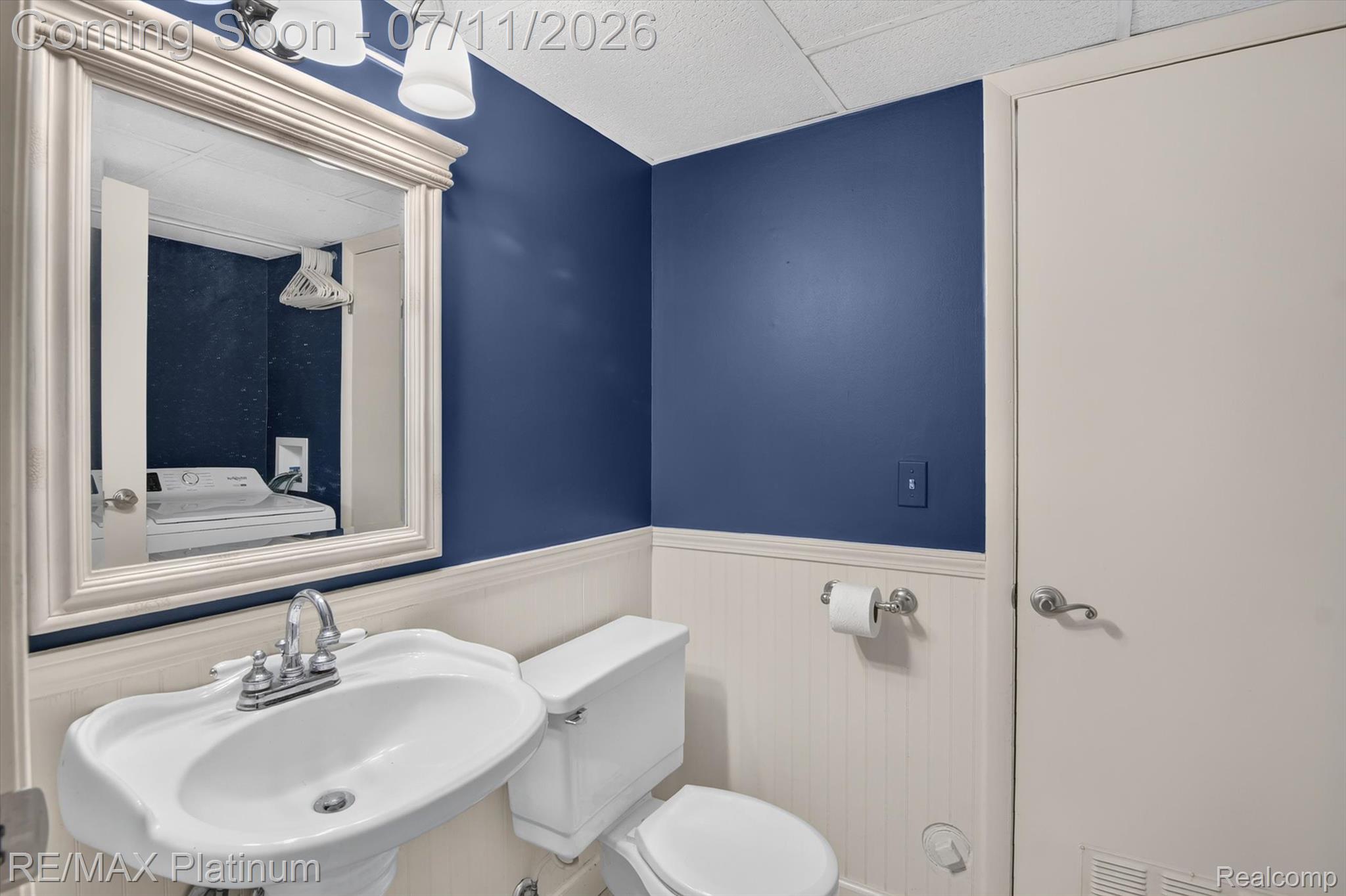 13365 North Territorial Road Gregory, MI 48137 - Photo 26 of 52 Bathroom featuring a white pedestal sink, toilet, and beadboard wainscoting