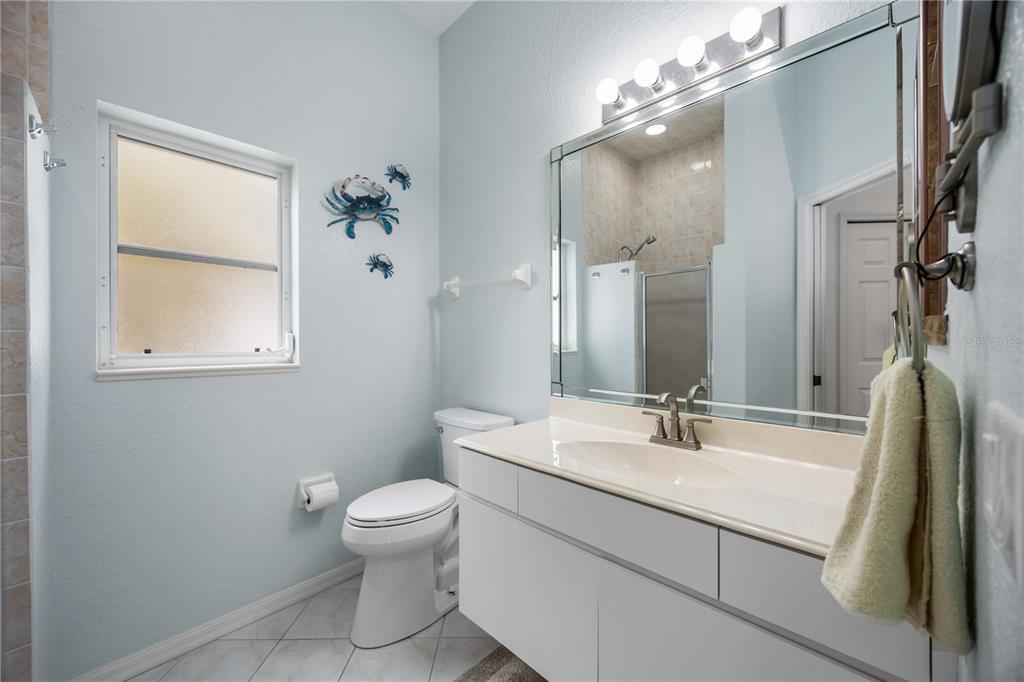 48 Bunker Road Rotonda West, FL 33947 - Photo 40 of 59 a bathroom with a sink a toilet and a mirror