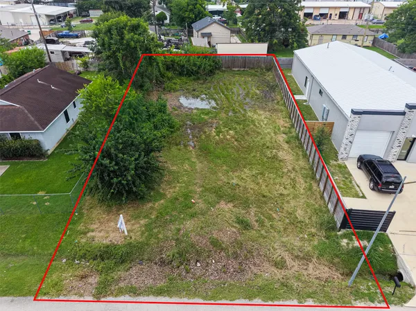 an aerial view of residential house with outdoor space and trees