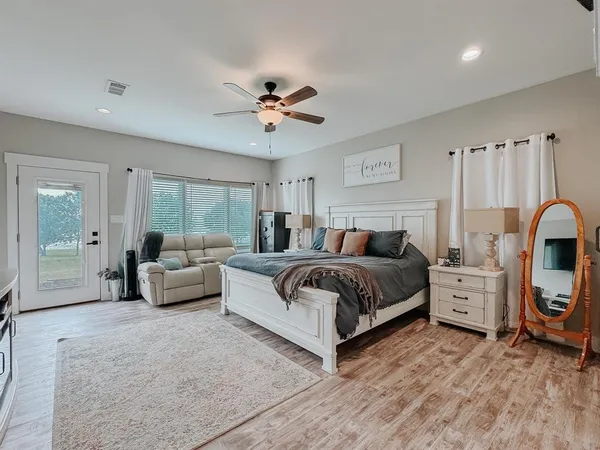 a spacious bedroom with a bed and a couch