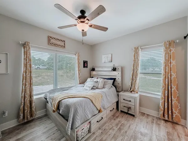 a bedroom with a large bed and a large window