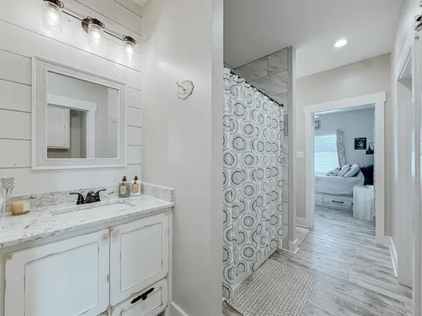a en suite bathroom with a sink a toilet and a mirror