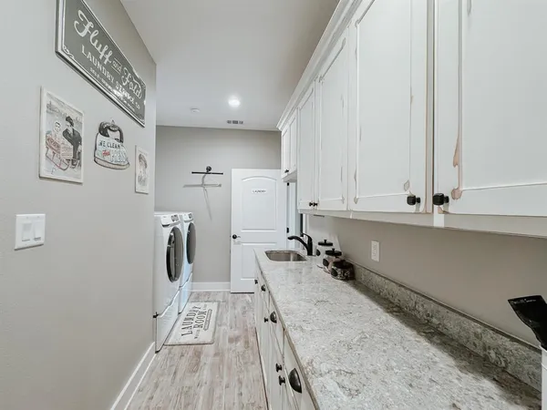 a view of a kitchen with fridge and wooden floor
