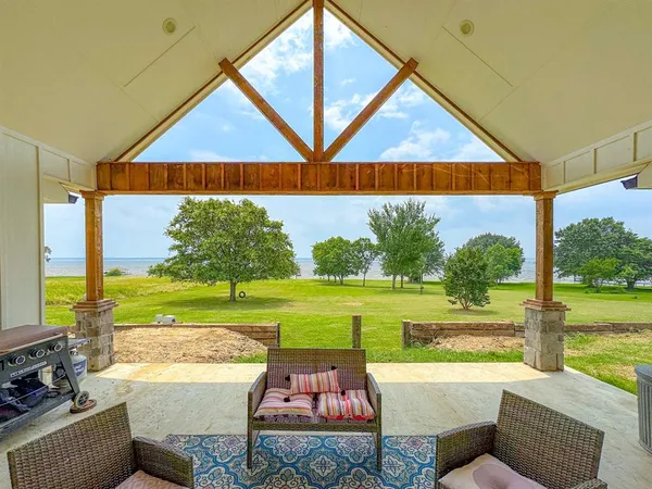 a view of a patio with a table chairs and a swimming pool