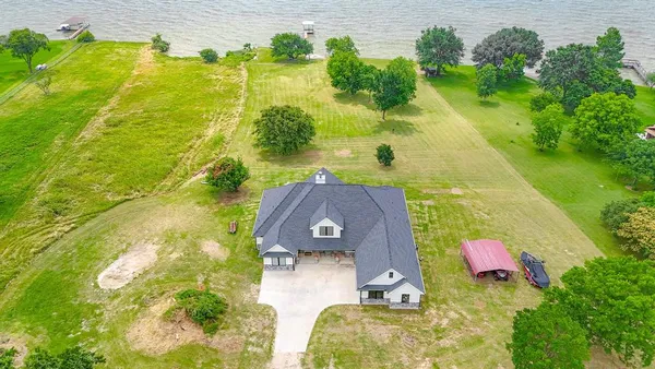an aerial view of a house with a yard
