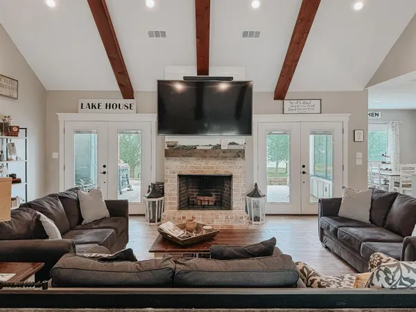 a living room with furniture fireplace and a flat screen tv