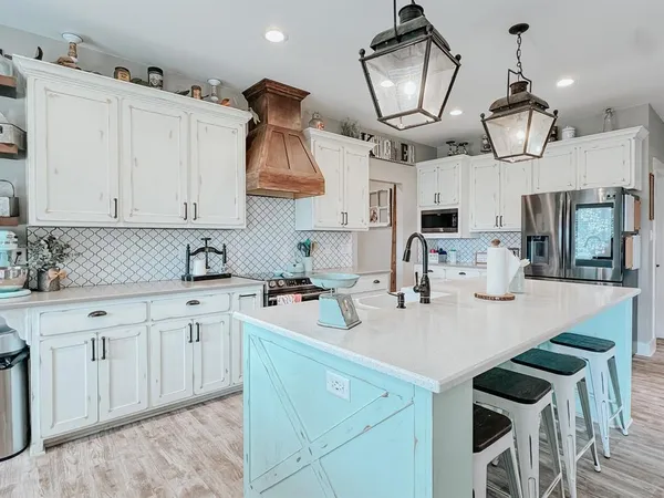 a kitchen with cabinets a sink and appliances