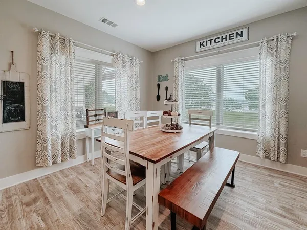 a view of a dining room with furniture window and wooden floor