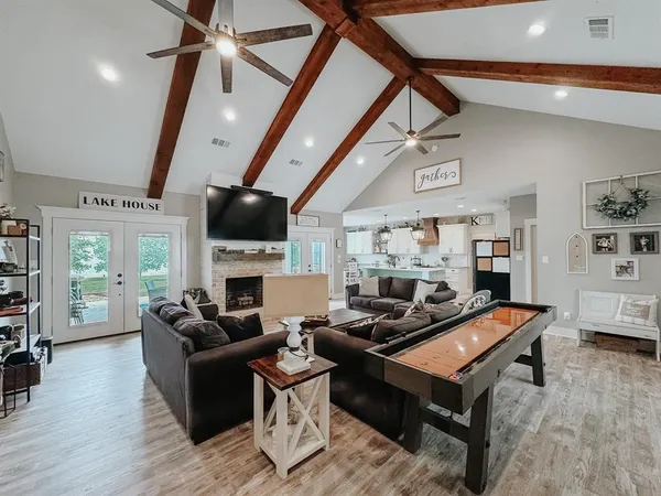 a living room with furniture a fireplace and a flat screen tv