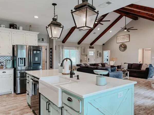 a kitchen with a sink a stove and cabinets