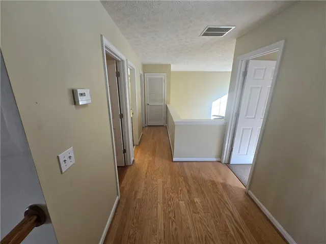 a view of a hallway with a staircase