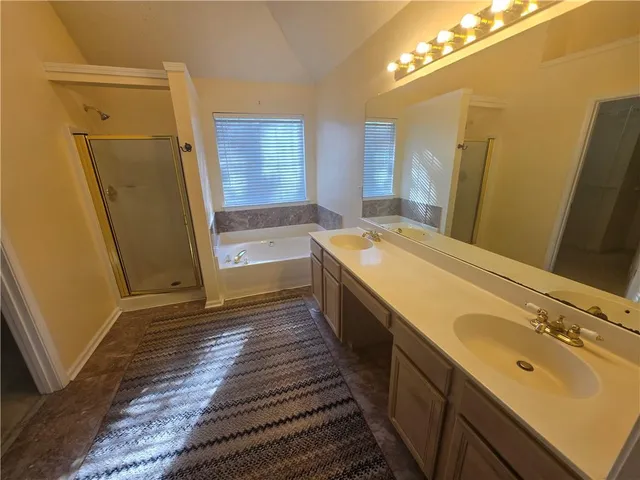 a bathroom with a sink a mirror and a bathtub