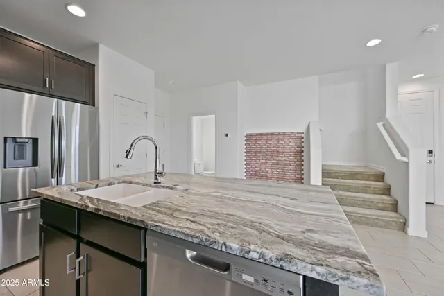 a kitchen with a sink stove and refrigerator