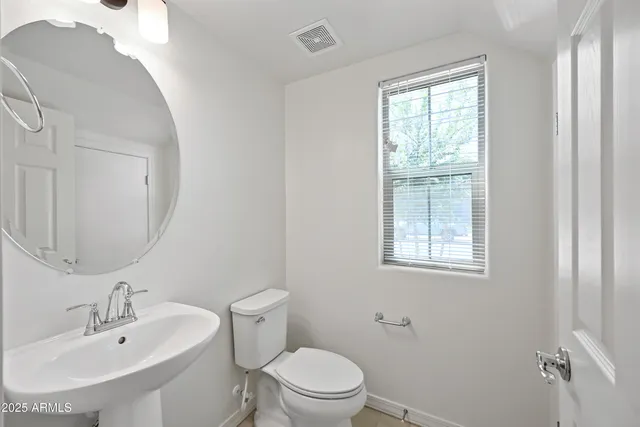 a spacious bathroom with a granite countertop sink and a mirror