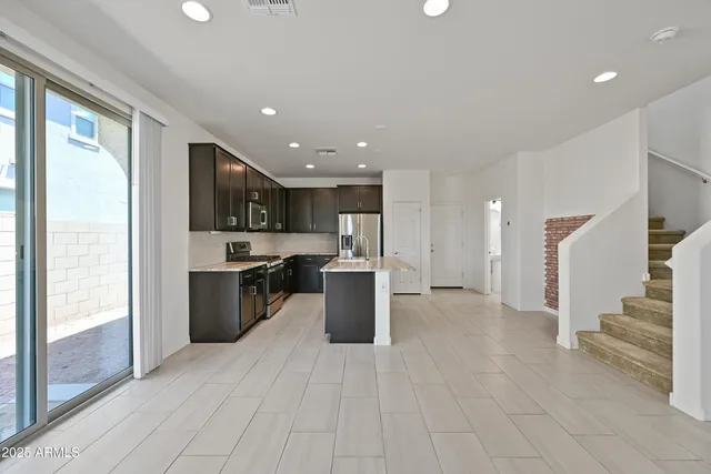 a view of a kitchen with a sink and a stove top oven