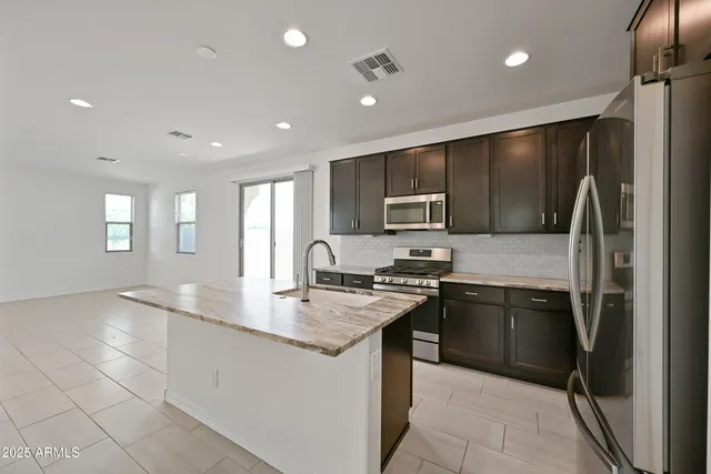 a view of kitchen with a sink and dishwasher a refrigerator with wooden floor