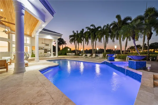 a view of swimming pool with outdoor seating and a patio