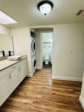 a spacious bathroom with a granite countertop sink and a mirror