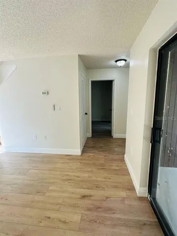 a view of hallway with wooden floor