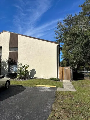 a view of a street with a building and trees in the background