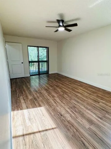 a view of wooden floor and windows in a room
