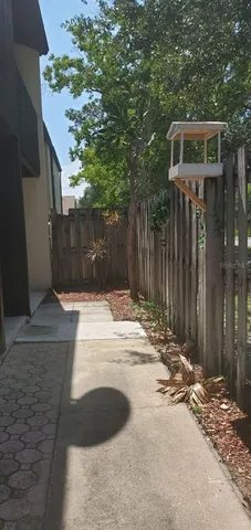 a view of a yard with wooden fence