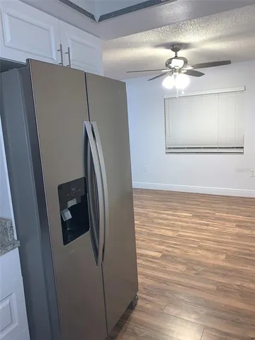 a view of a livingroom with a refrigerator