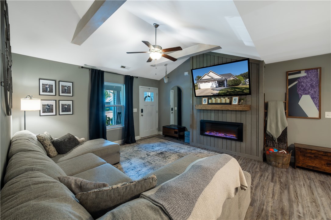400 Green View Court Westminster, SC 29693 - Photo 4 of 23 This living area features a warm fireplace and stylish wood flooring, perfect for comfortable living.