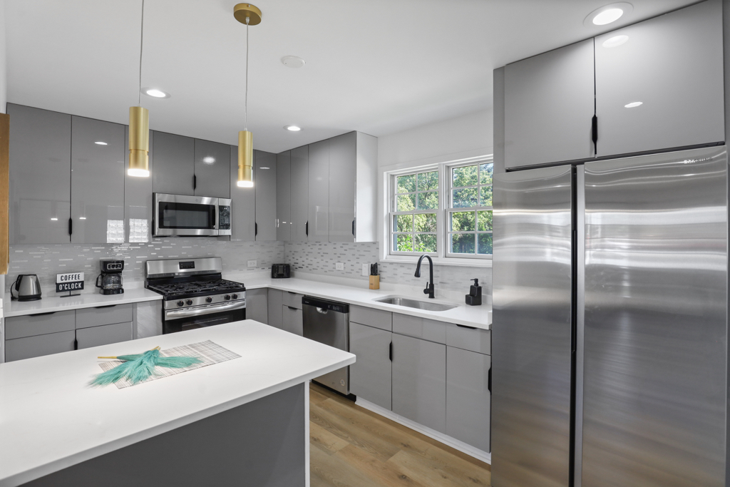 7125 Simpson Street Morton Grove, IL 60053 - Photo 13 of 33 a kitchen with a sink stainless steel appliances and white cabinets