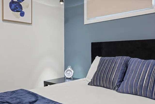 a bedroom with bed and a window