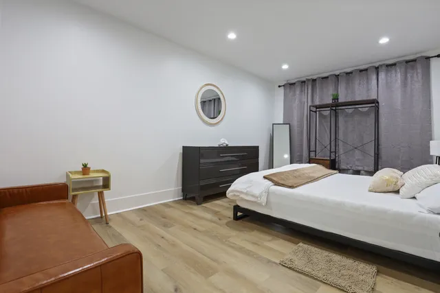 a bedroom with a bed and a night stand