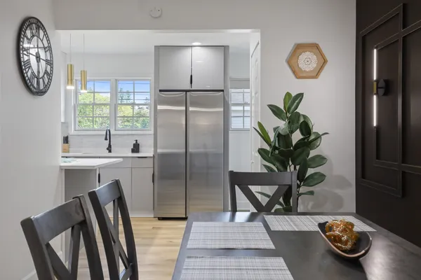 a view of a kitchen with fridge and window