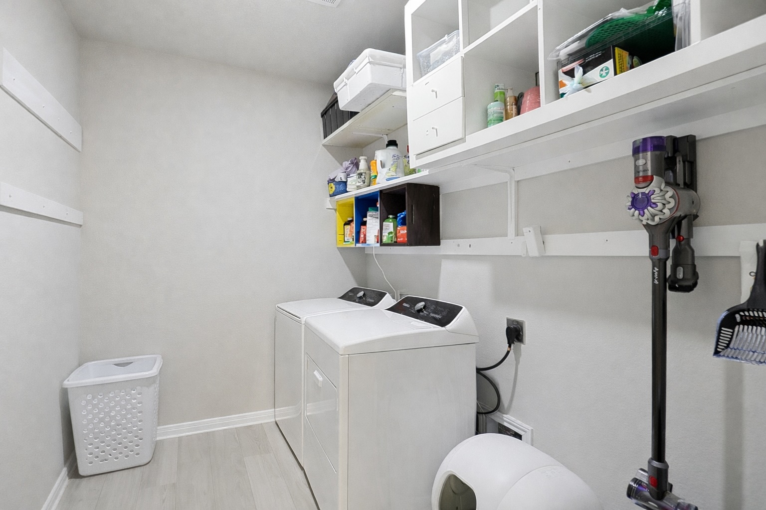 12206 Purple Prairie Lane Buda, TX 78610 - Photo 18 of 24 The laundry room offers plenty of storage space.