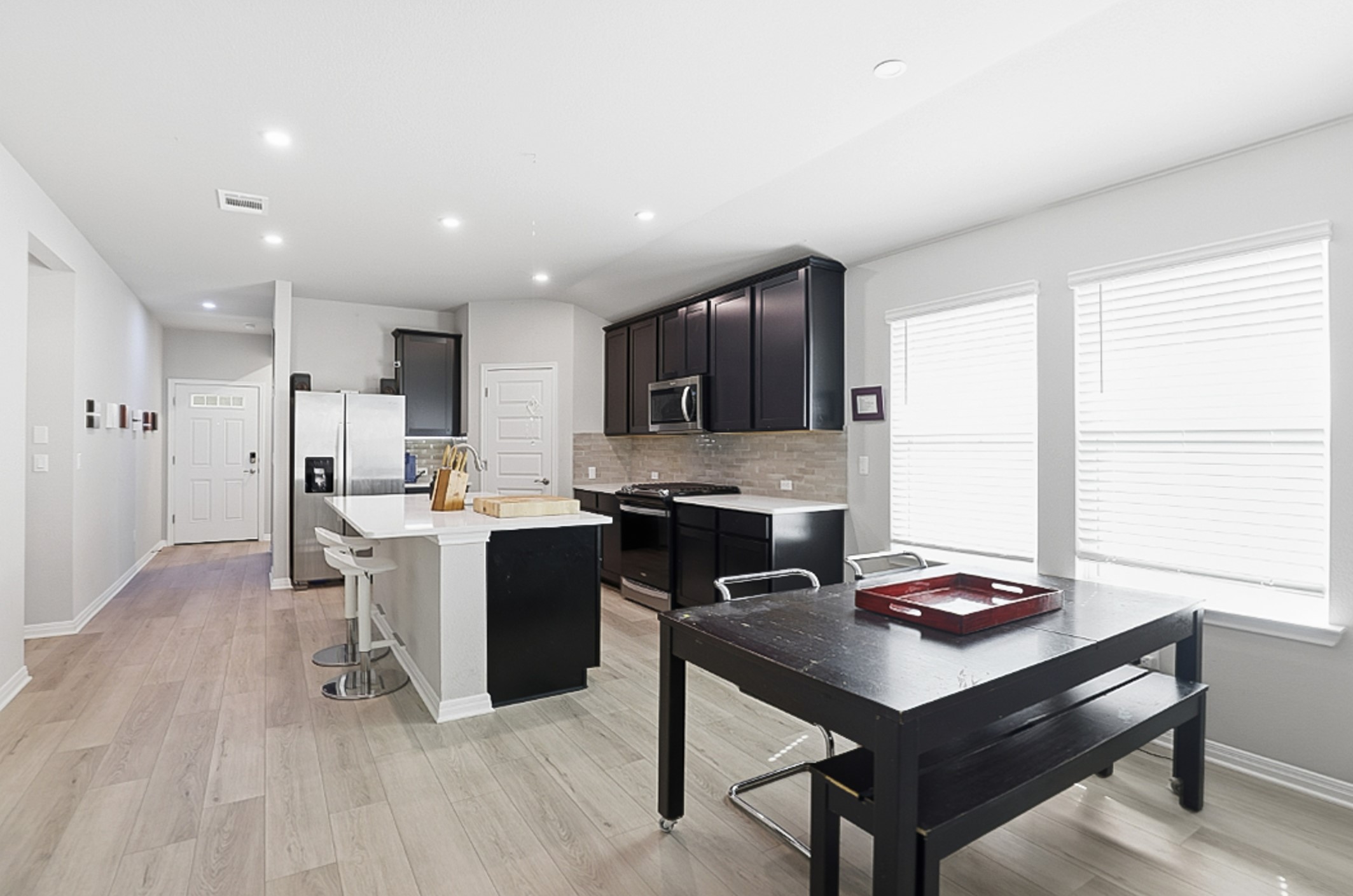 12206 Purple Prairie Lane Buda, TX 78610 - Photo 7 of 24 The dining area is positioned between the kitchen and living room, perfect for entertaining.