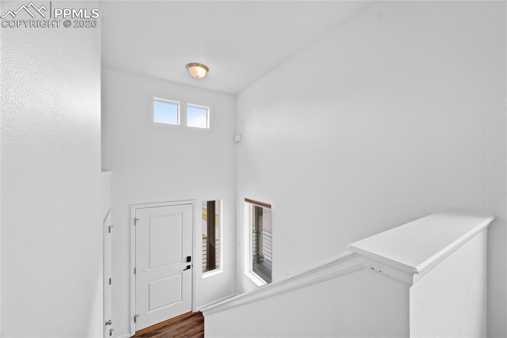 9414 Timberlake Loop Colorado Springs, CO 80927 - Photo 6 of 40 Foyer featuring dark luxury vinyl wood finished floors and a high ceiling