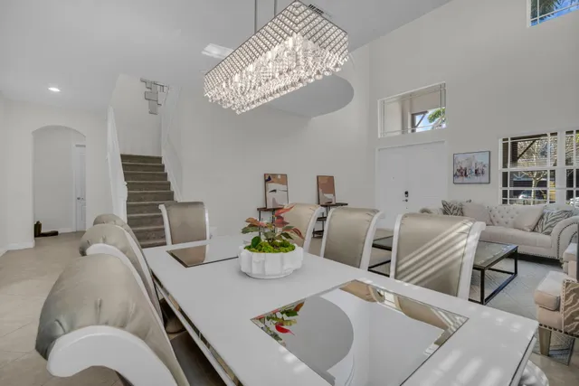 a kitchen with stainless steel appliances granite countertop a sink a stove and a wooden floors