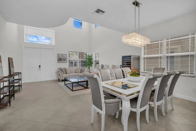a kitchen with stainless steel appliances granite countertop a stove top oven a sink and white cabinets
