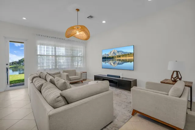 a kitchen with stainless steel appliances granite countertop a sink and a stove top oven with white cabinets