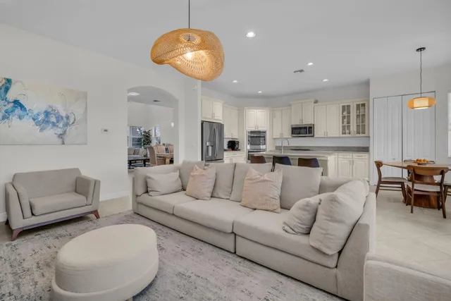 a kitchen with stainless steel appliances granite countertop a sink a stove and a wooden floors